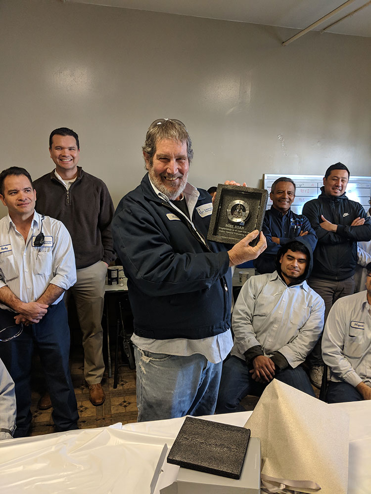 man holding up award
