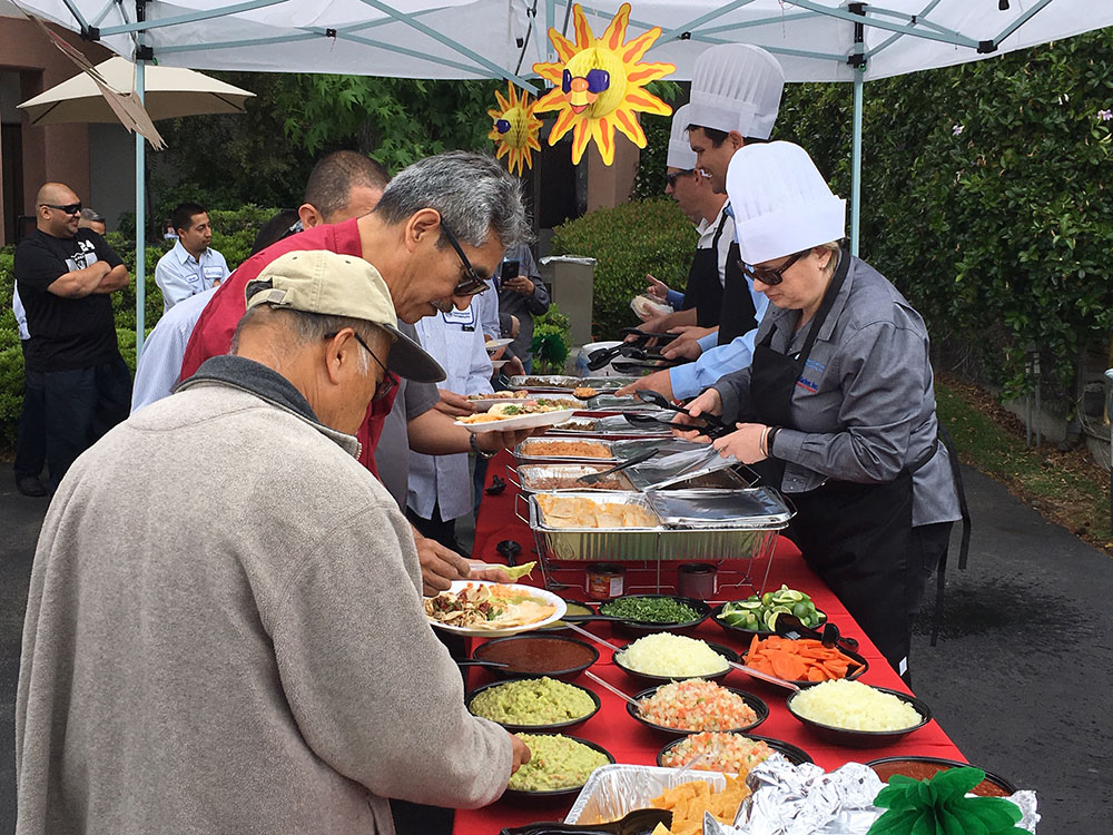 people in line getting food
